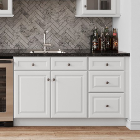 White kitchen cabinets, granite countertop with bottles